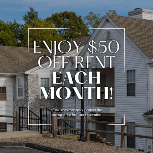 A house with a sign offering $50 off rent each month.