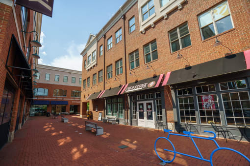 Brick storefront with benches in front at The Residences of Creekside.