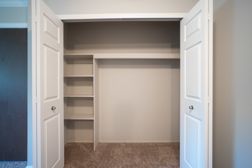 Large closet with shelving and bifold doors