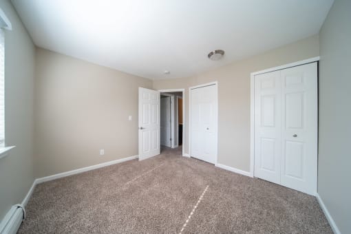 Bedroom with carpet and closet doors