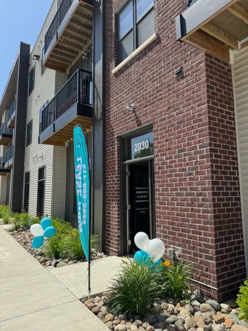 a brick building with balloons in front of it