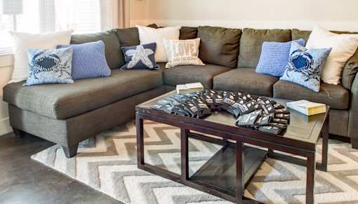 A living room with a grey couch and a coffee table.