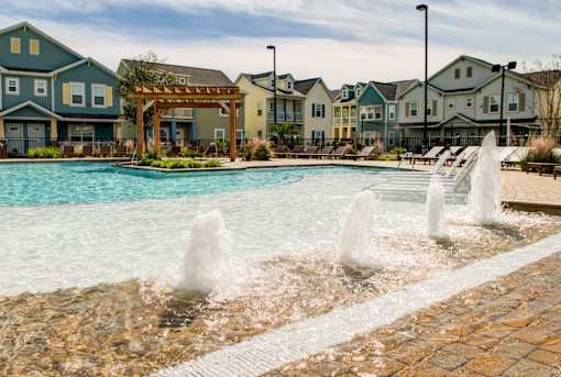 A pool with a fountain in the middle of it.