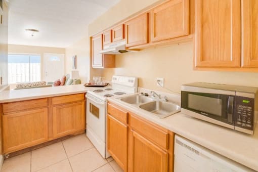 kitchen with tan counters and wooden cabinets.