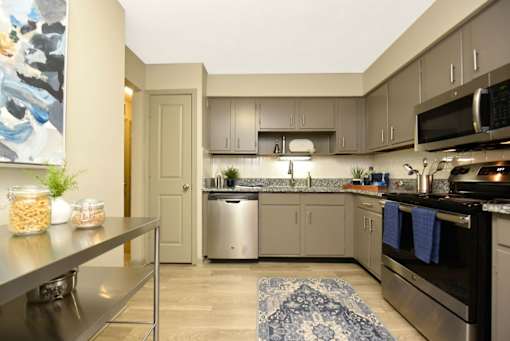 a kitchen with stainless steel appliances and granite counter tops