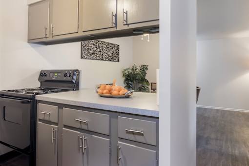 A modern kitchen with a stove, oven, and cabinets.