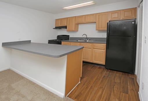 Renovated kitchen area with wood flooring