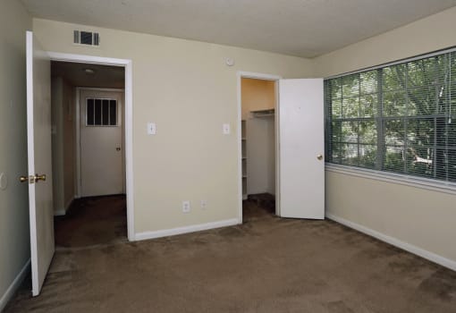 Bedroom with plush carpeting and closet