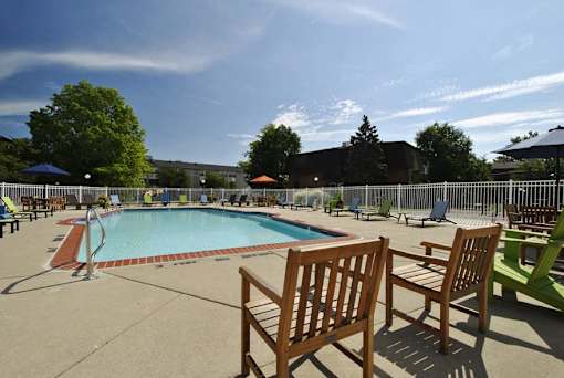 A pool area with chairs and a slide.