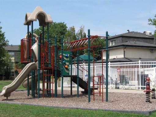 A playground with a green and red slide.