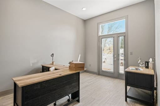 a bedroom with a desk and a door to a patio