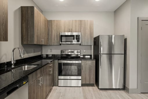 a kitchen with stainless steel appliances and wooden cabinets