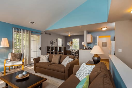 A living room with a brown couch and a coffee table.