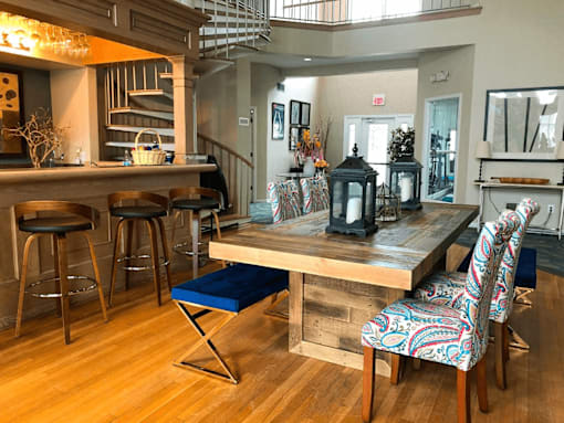 A dining area with a wooden table and chairs.