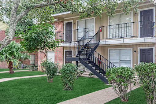 A tree is in front of a house.