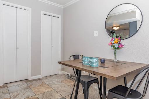 A dining room with a wooden table and chairs.
