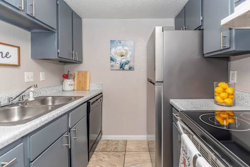 A kitchen with a stove top oven and a sink.