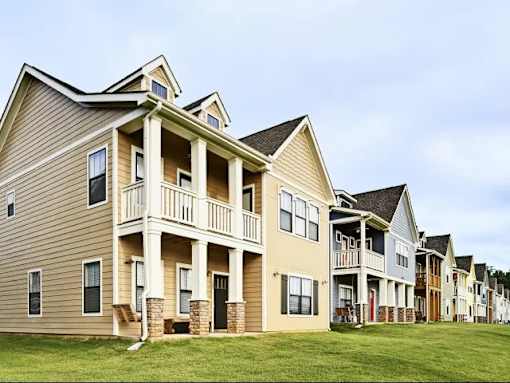A row of townhouses with balconies and front porches.