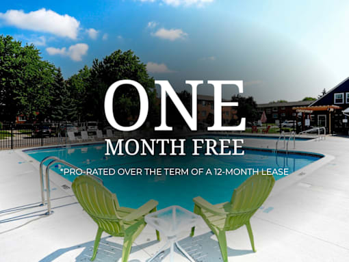 A pool with two green chairs and the text "ONE MONTH FREE" on a sunny day.