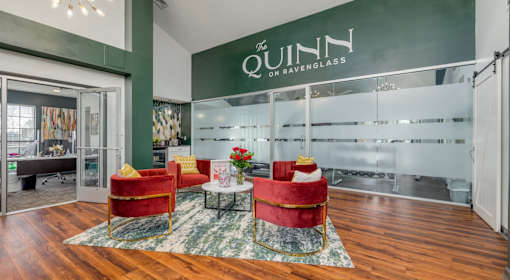 A room with a glass wall and a sign that says "The Quinn on Raven Glass".