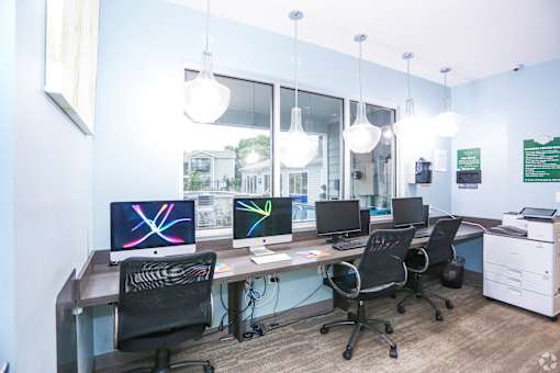 A modern office with computers and chairs.