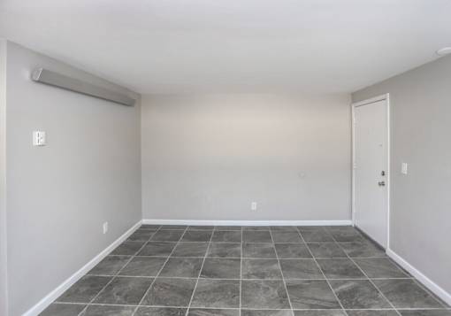 A room with a sliding door and tile flooring.