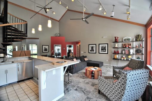 a large living room with a kitchen and a table at Village Club on Franklin, Southfield, MI