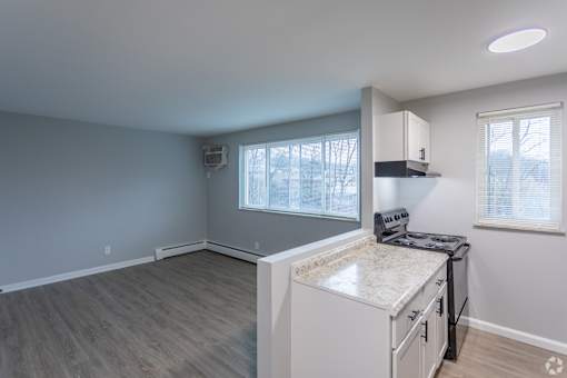 A kitchen area with a countertop and cabinets.