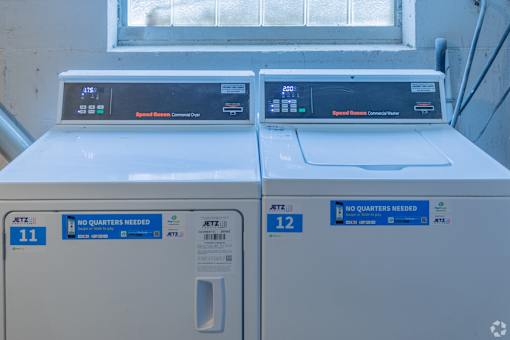 Two identical washing machines are side by side.