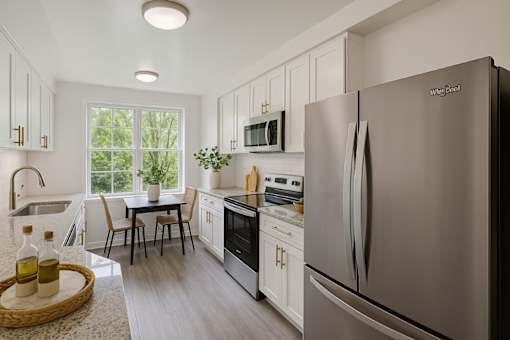 A modern kitchen with a Whirlpool refrigerator.