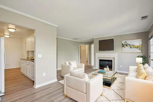 A living room with a fireplace and a painting on the wall.