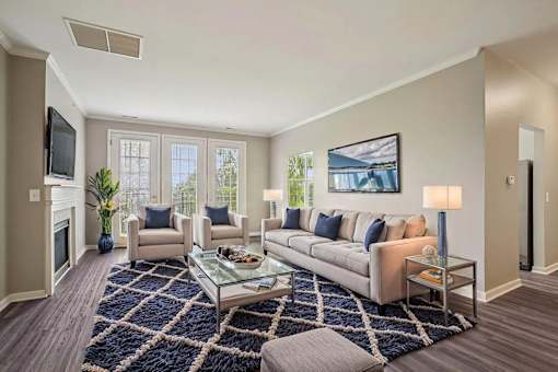 A living room with a couch, chairs, and a coffee table.