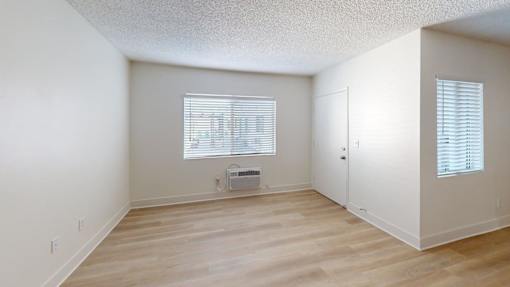 A room with a window and a door.