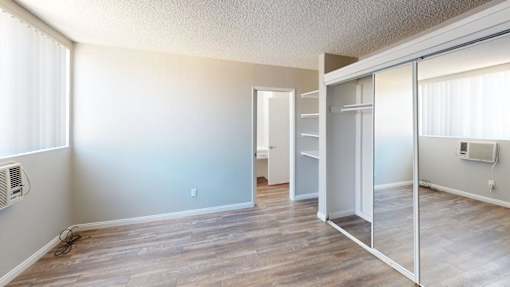 A room with a sliding glass door and a window.