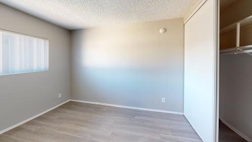 A room with a window and a door.
