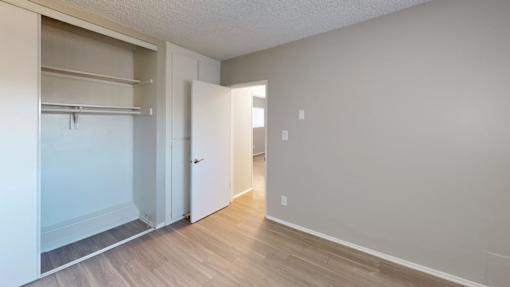 A room with a white door and a white wall.