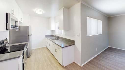 A kitchen with a stove top oven and a dishwasher.