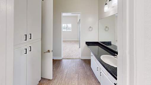 A bathroom with a sink and a mirror.