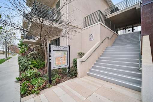 A building with a staircase and a sign that says