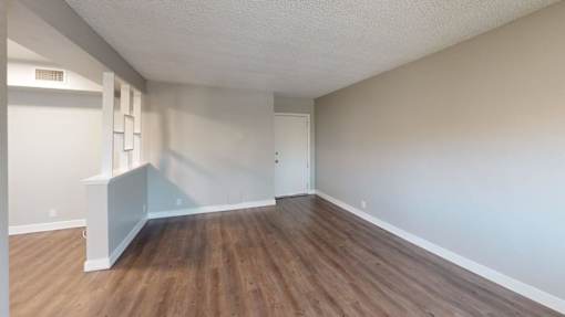 A room with wooden floors and white walls.