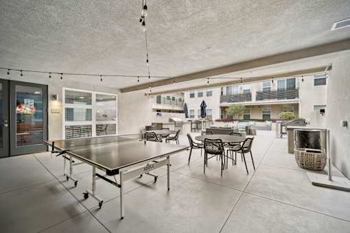 A modern patio with a table and chairs.