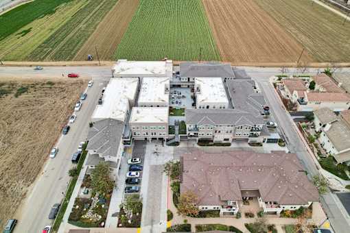 A large building with a parking lot in front of it.