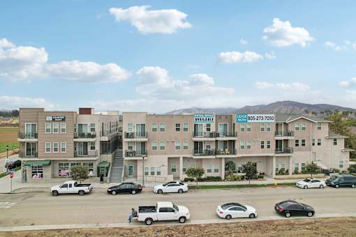 A large apartment complex with a sign that says