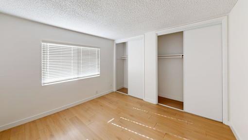 A room with wooden floors and white walls.