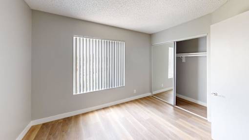 A room with a wooden floor and a white door.