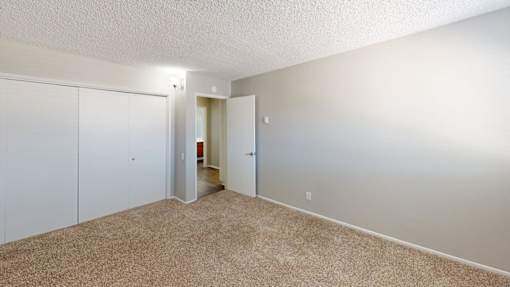 A room with carpeted floor and white walls.