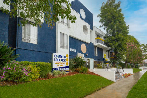 a blue and white building with a sign in front of it