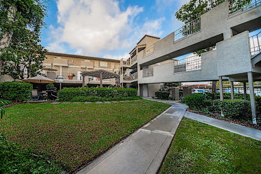 A concrete building with a walkway in front of it.