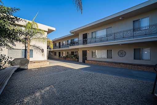 A sunny day at a residential complex with a clear blue sky.