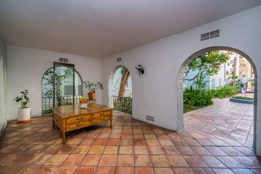 A room with a tiled floor and a wooden table.
